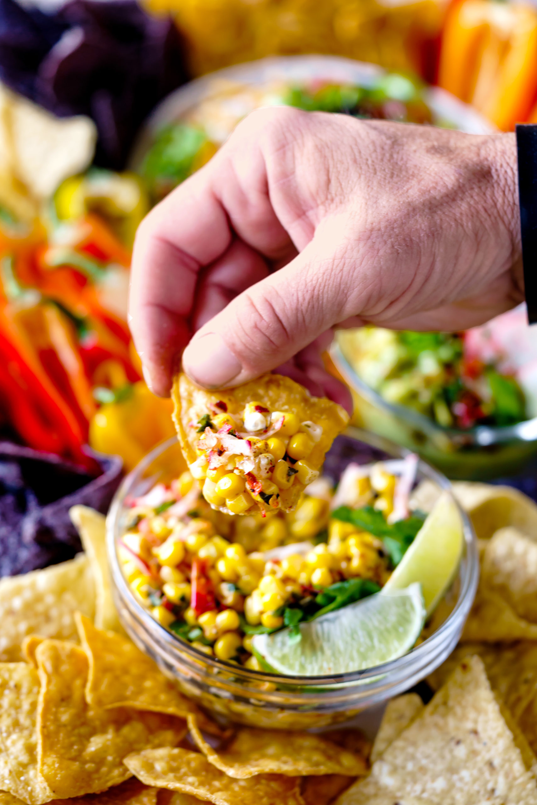 Mexican Corn Dip served with chips and crispy vegetables.